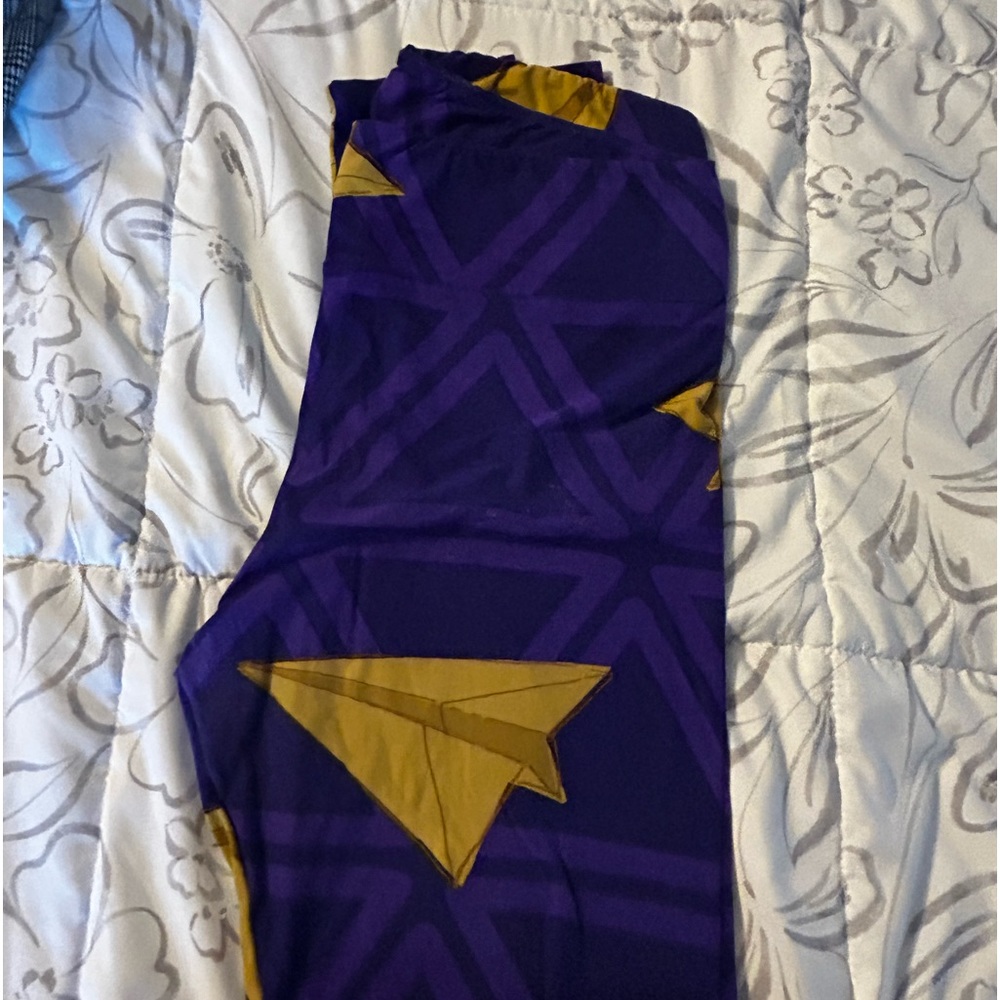 Purple and mustard leggings with paper airplanes